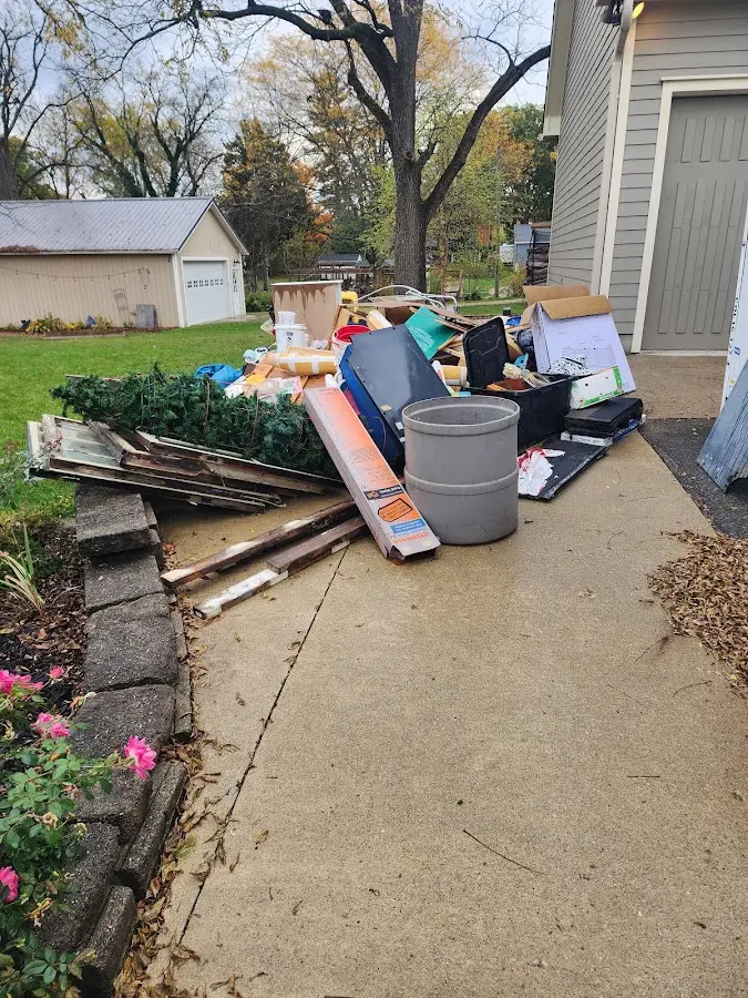 Dumpster being loaded with debris for Estate Cleanout Dumpster Rental in Ocean City